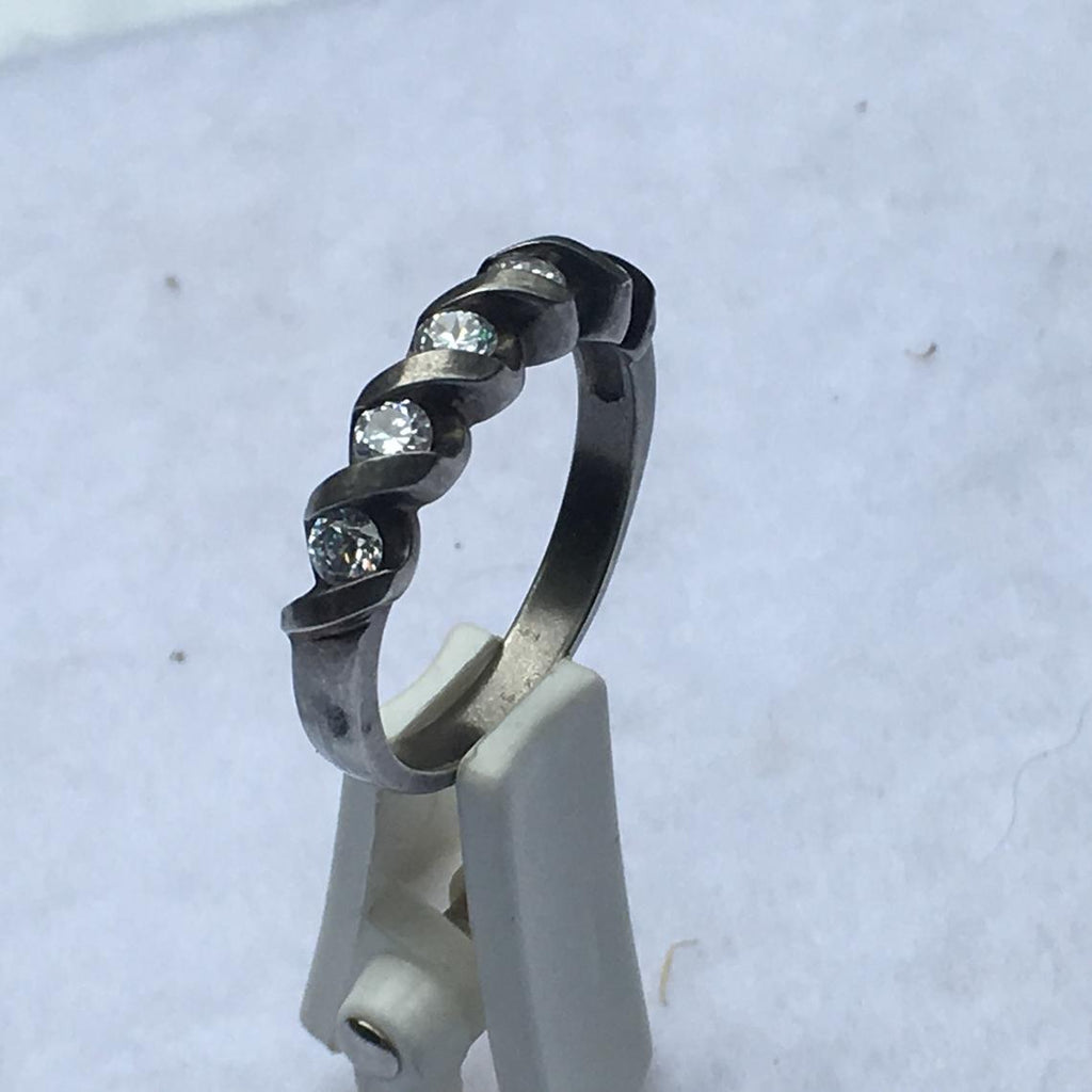 The settings on the ring face has a unique crisscross pattern adding to the flair and style of this piece of jewelry. Older ring, has some tarnish but should clean up nicely.