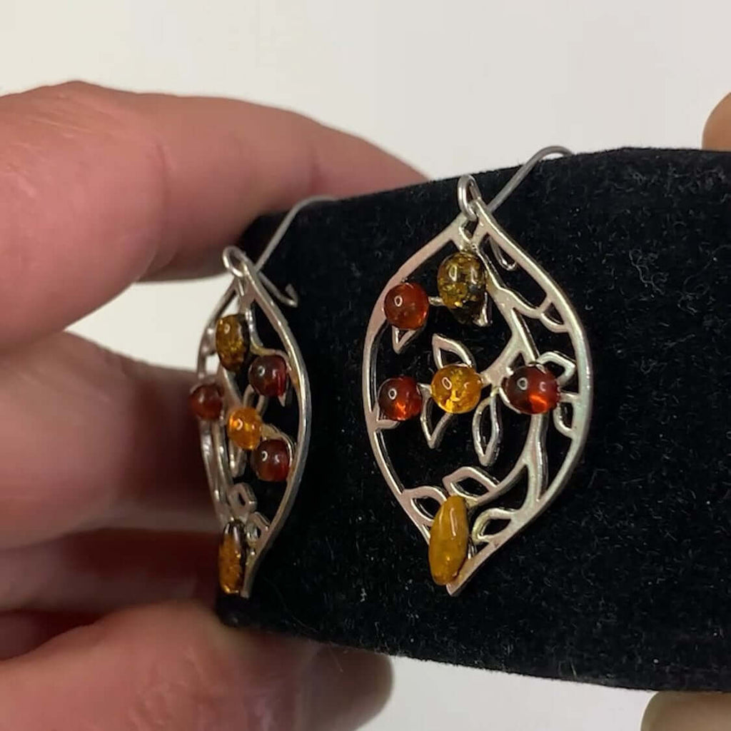 Sterling Silver 925 Amber Leaf Design Drop Dangle Earrings with 6 Amber Stones in Cognac, Green, and Yellow hues displayed on black stand