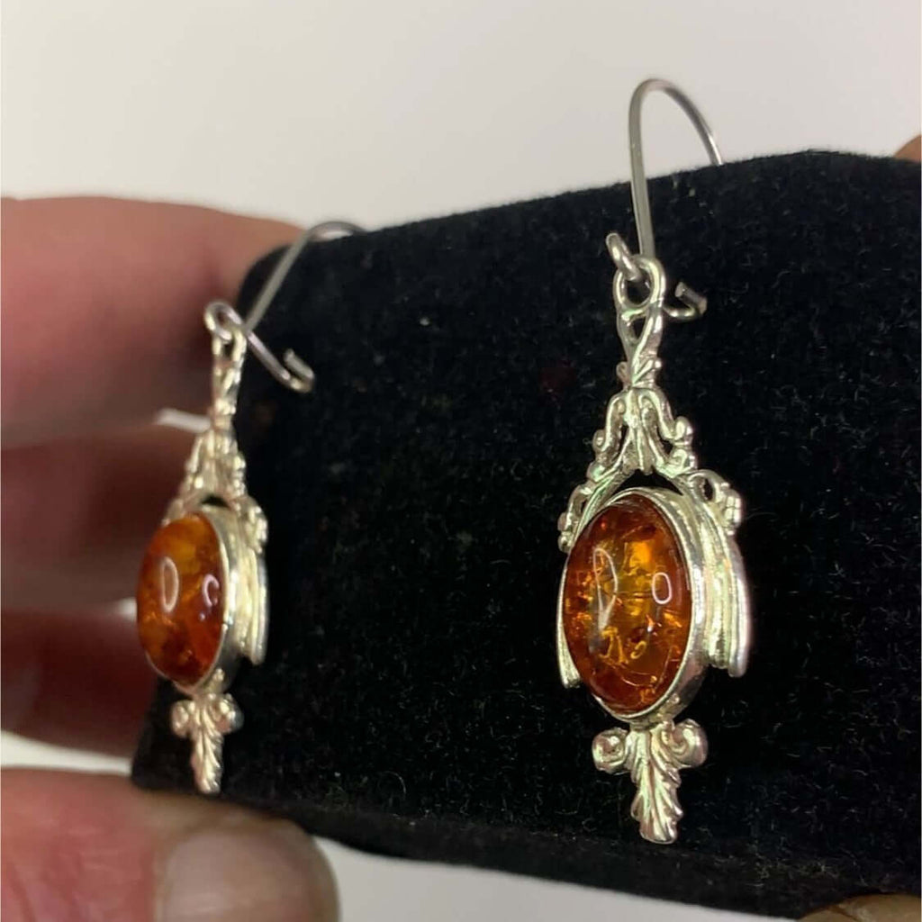 Sterling silver dangle earrings with cognac amber stones, perfect for women's fashion and versatile enough for any occasion.