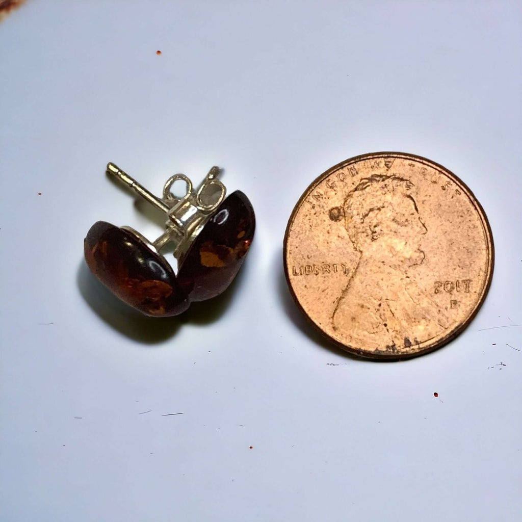 Sterling silver 925 cognac freestanding oval stud earrings next to a penny for size comparison, showcasing stunning colors and elegant design