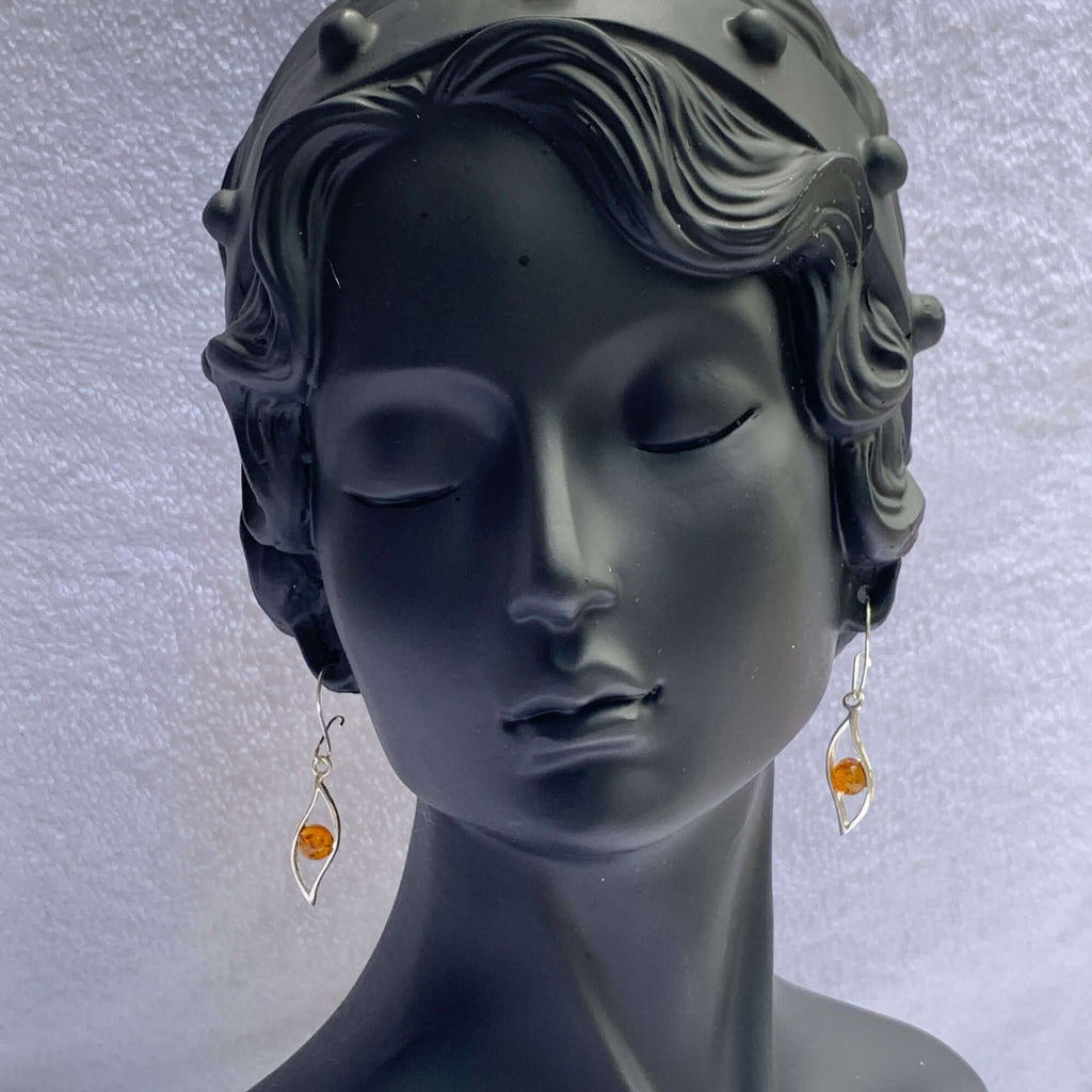 Sterling Silver 925 Cognac Amber Dangle Earrings on elegant bust mannequin, featuring small amber centerpieces and delicate leaf design.