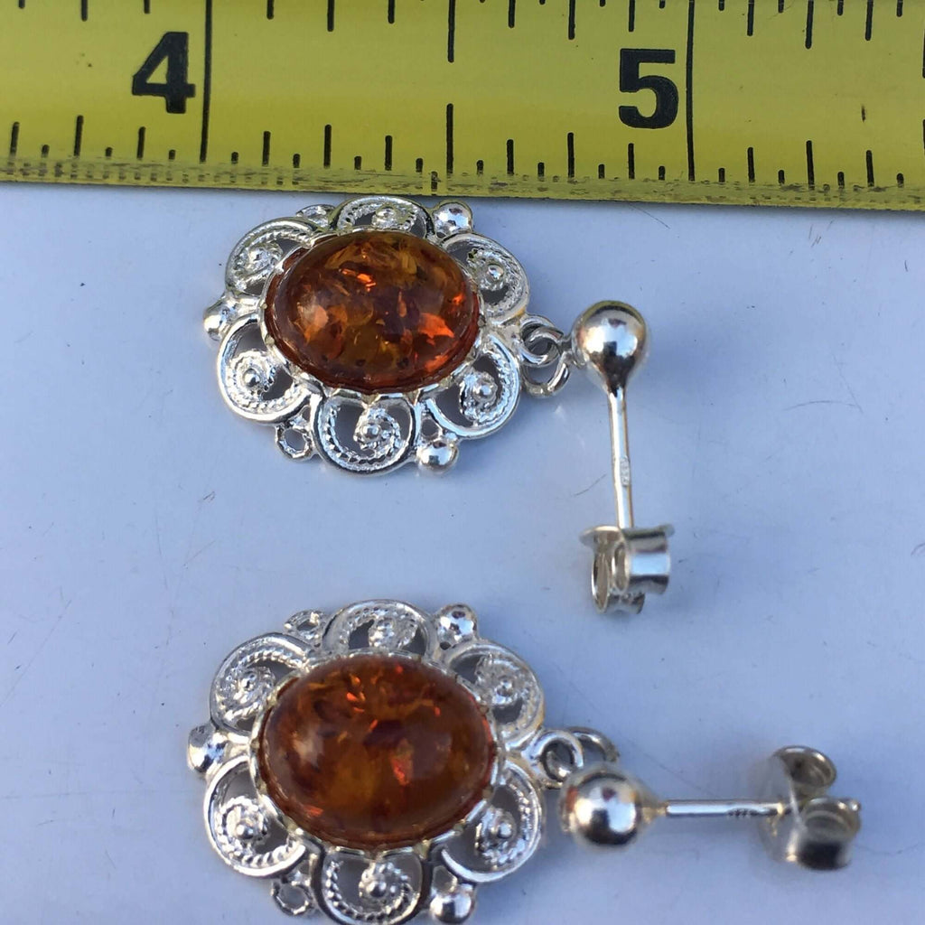 Sterling silver 925 women's cognac amber stud drop earrings with intricate swirl pattern measured against a ruler.