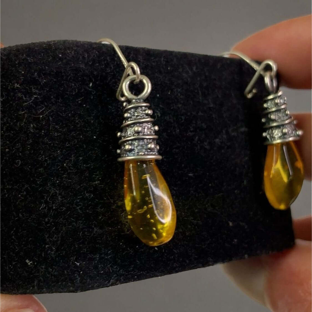 Sterling Silver 925 Women's Yellow Amber Dangle Earrings with Elegant Wrapping Accents on Black Display