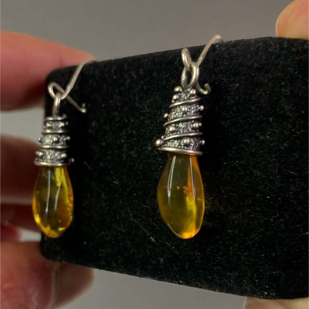 Sterling Silver 925 Women's Yellow Amber Dangle Earrings with Elegant Wrapping Accents and Inclusions on Black Display