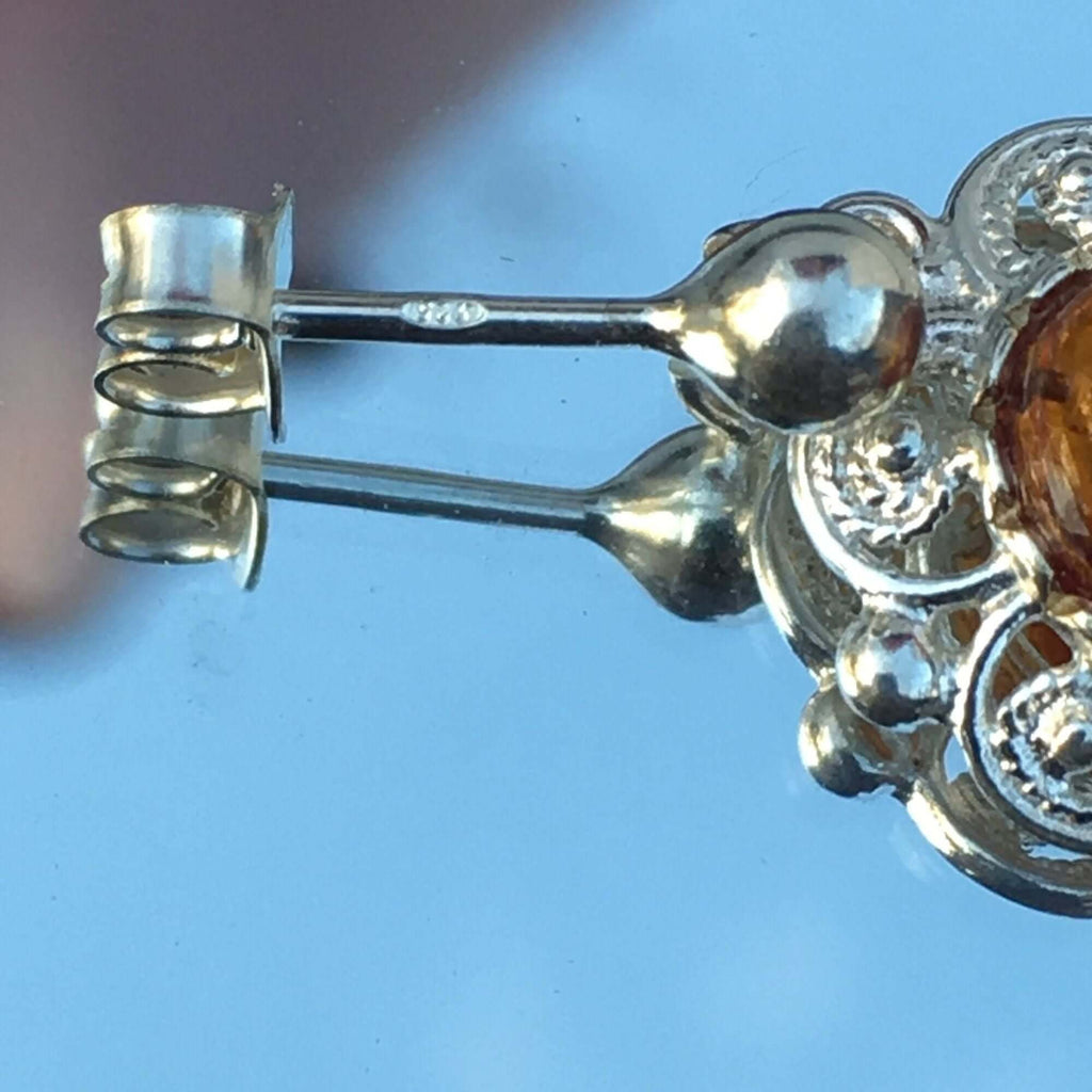 Sterling silver 925 women's cognac amber stud drop earrings with intricate swirl and dot pattern and silver ball post.