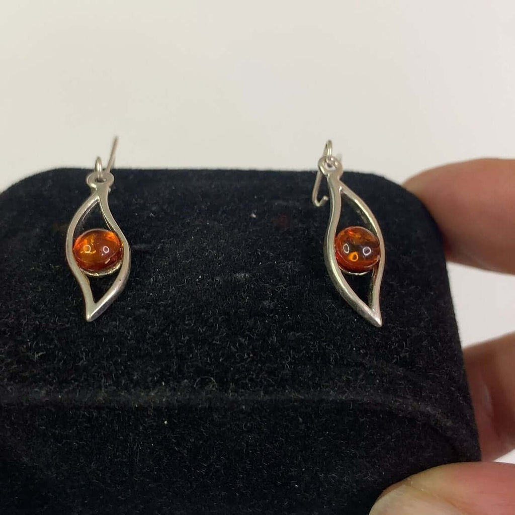 Sterling Silver 925 Cognac Amber and Leaf Pattern Dangle Earrings on a Display Stand